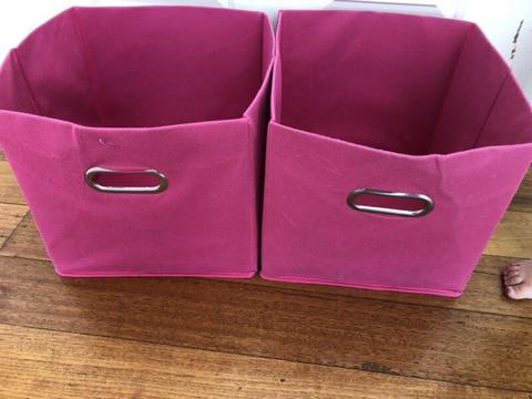 Two pink mocka storage boxes