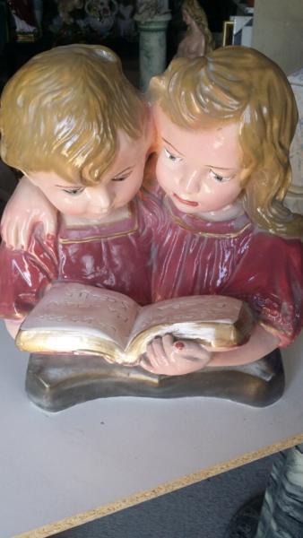 Plaster couple reading book