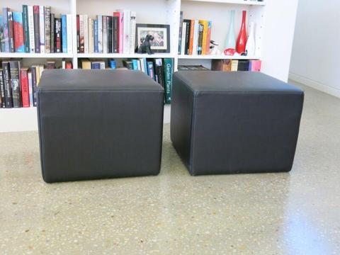 Three (3 )black leather look ottomans in very good condition