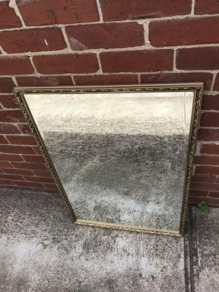 Beveled edge mirror in decorative frame