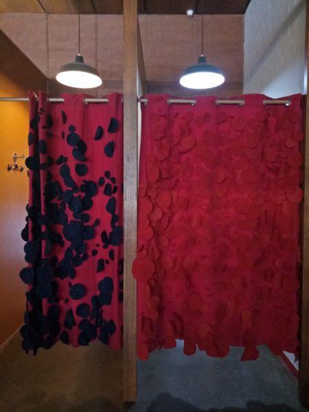 Five brightly coloured felt curtains