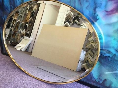 Oval brass wall mirror $150
