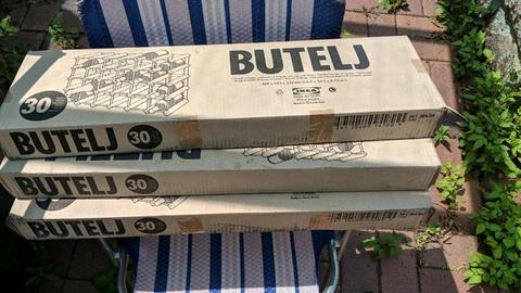 Three unopened IKEA wine racks