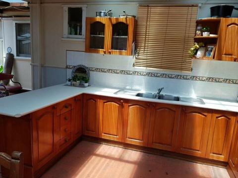 Wooden kitchen including oven