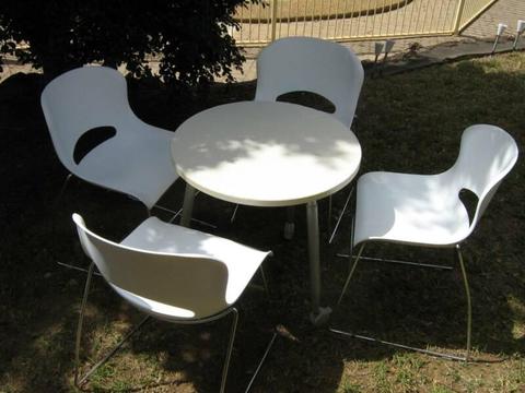 Timber table on castors with 4 white plastic / chrome chairs