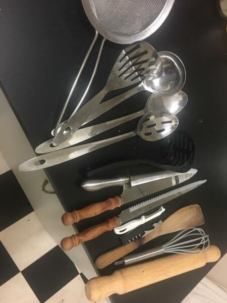 Kitchen utensils including knives, chopping boards, grater,masher