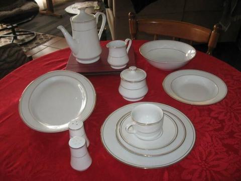 Gold rimmed white dinner set, including access. Ex condition