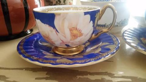 T2 teacups and saucers . Blue,gold and cream roses