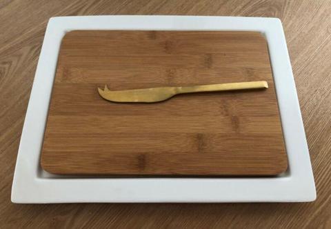 Papaya wooden cheese board and white china platter