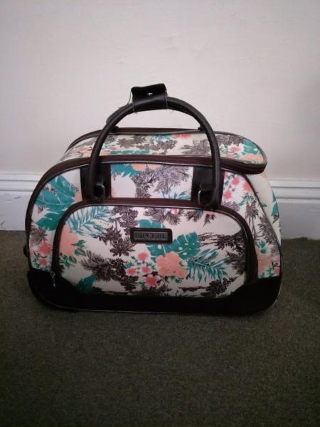 Rip Curl extra light carry on suitcase. Floral/Tropical pattern