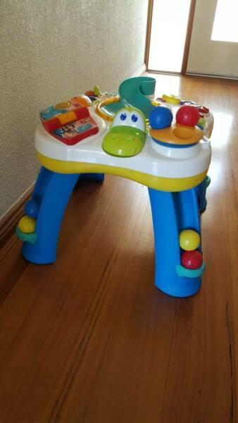 Activity table, baby toys and books