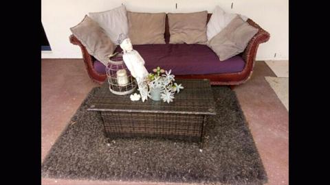 Garden sofa, coffee table, carpet, Buddha, candlestick, cushions