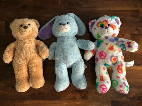 Four Build-a-Bears with lots of outfits