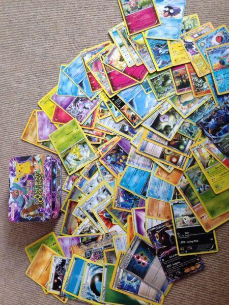 Over 100 Pokemon cards plus tin