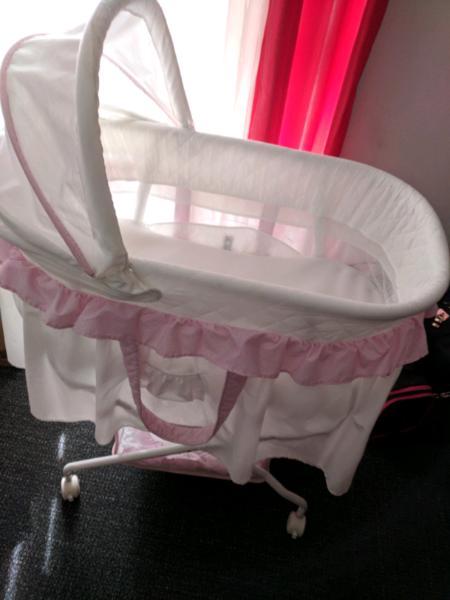 pink and white bassinet