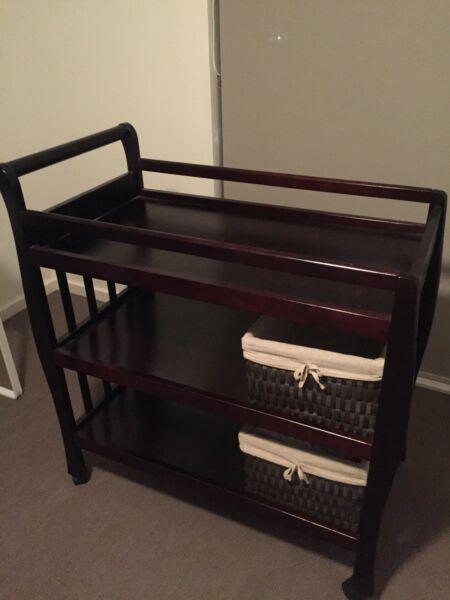 Walnut stained wooden sleigh cot and change table
