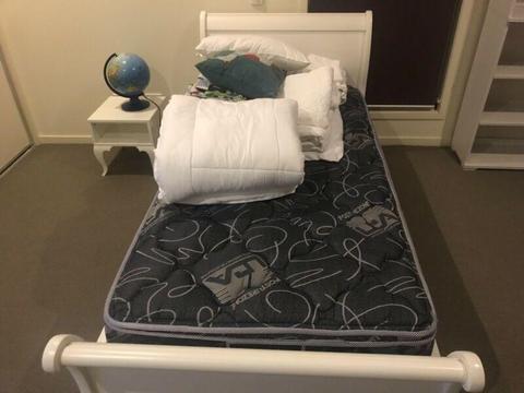 Single bed with mattress and sheets