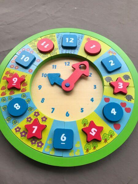 Wooden clock with pull out numbers