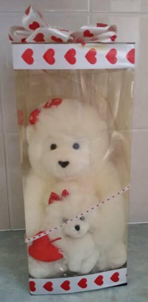 2 Very Cute White Cuddly teddy bears large and small in a plastic