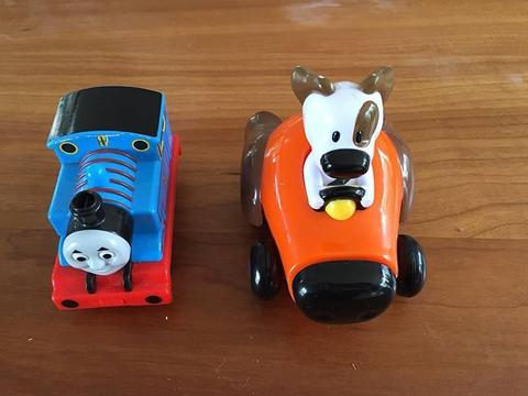 Thomas the tank engine toy with dog in a car
