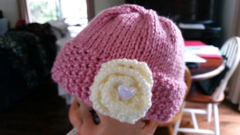 Babies Hand Knitted Cloche/Beanie/Hat. Pink with White Rose