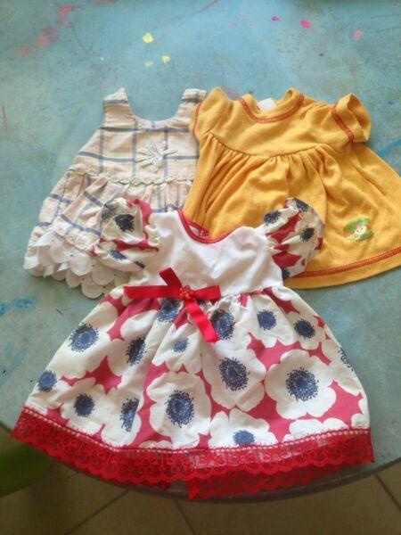 Doll And Assorted Baby Clothes