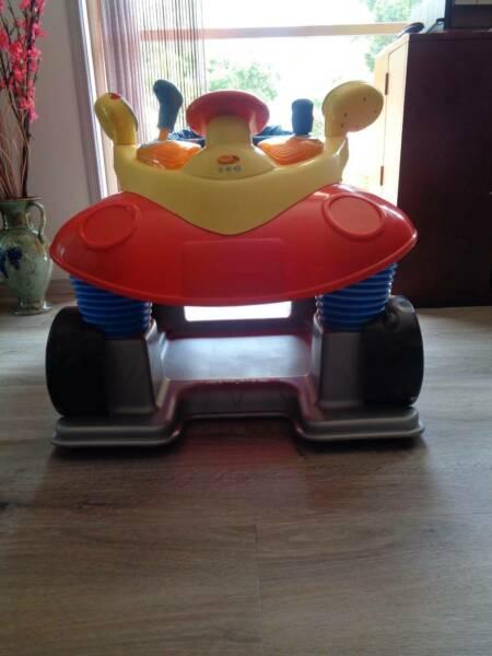 RED BOUNCING ROCKING TOY CAR WITH SOUNDS OF A REAL CAR