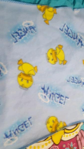 Baby blue blanket with ducks and the word angel