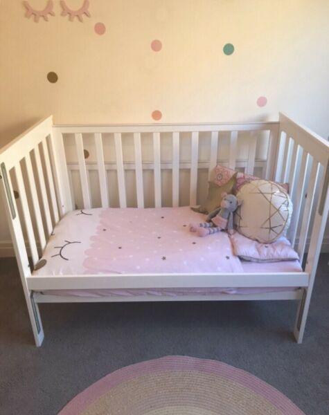 White wooden cot and matching change table