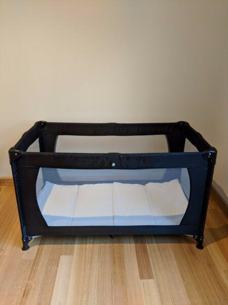Good sized travel cot with mattress
