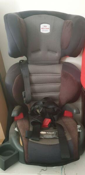 Booster seat with harness attachment
