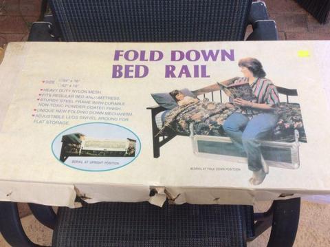 Fold down bed rail